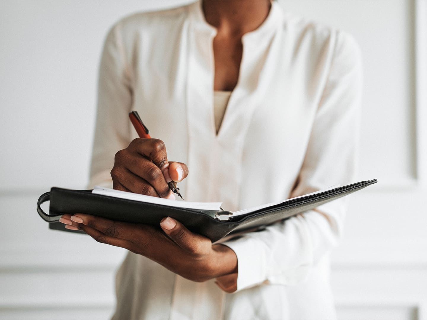 Woman writing on a notepad