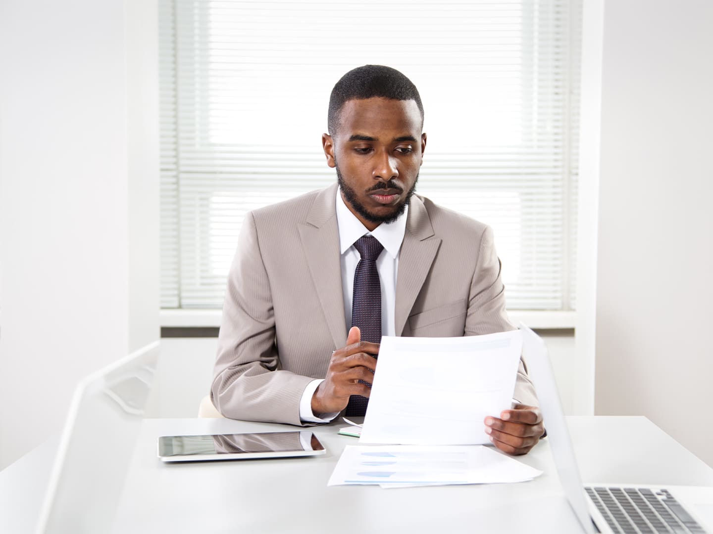 Man in suit analyzing a document